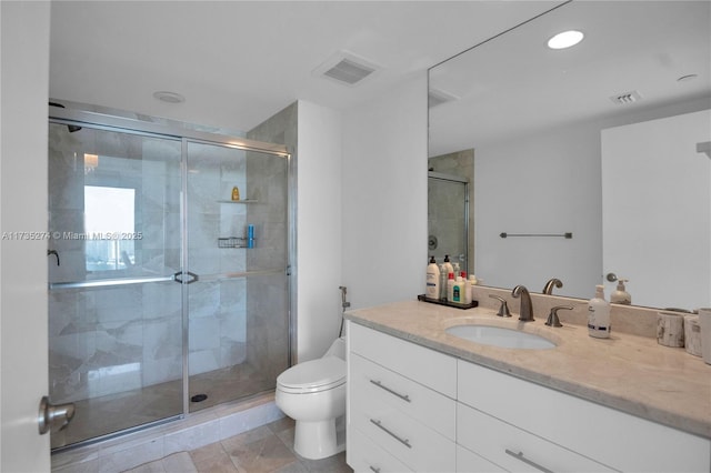 bathroom featuring an enclosed shower, vanity, tile patterned flooring, and toilet