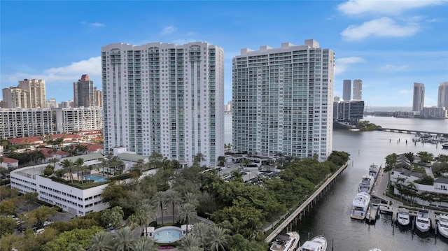 birds eye view of property with a city view and a water view