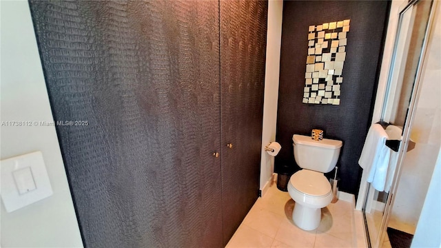 bathroom featuring tile patterned flooring and toilet