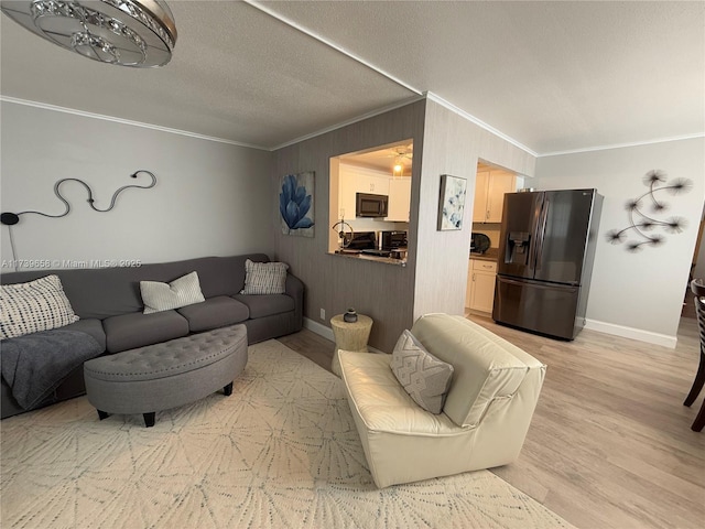 living room with crown molding, light hardwood / wood-style flooring, and a textured ceiling