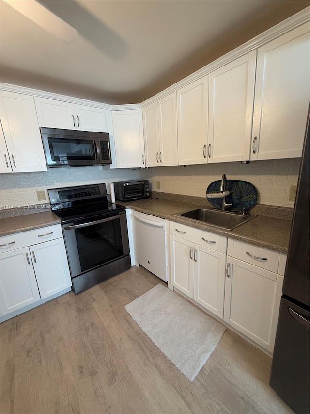 kitchen with sink, dishwasher, electric range, light hardwood / wood-style floors, and white cabinets