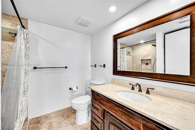 bathroom featuring walk in shower, vanity, and toilet