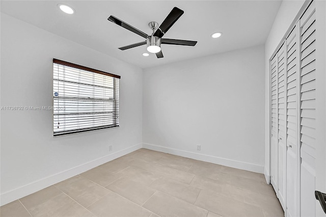 unfurnished bedroom featuring light tile patterned floors, ceiling fan, and a closet