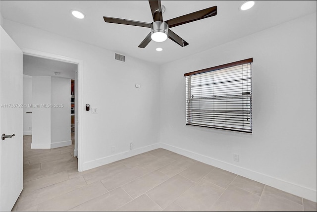 tiled empty room featuring ceiling fan