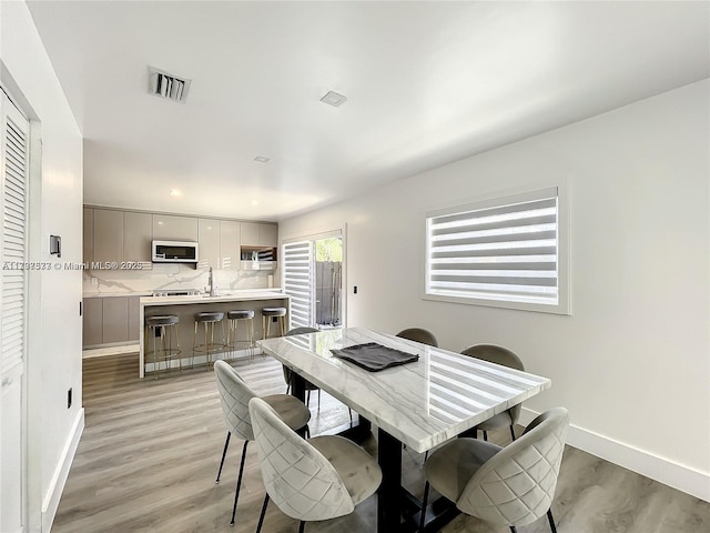 dining area featuring light wood-type flooring