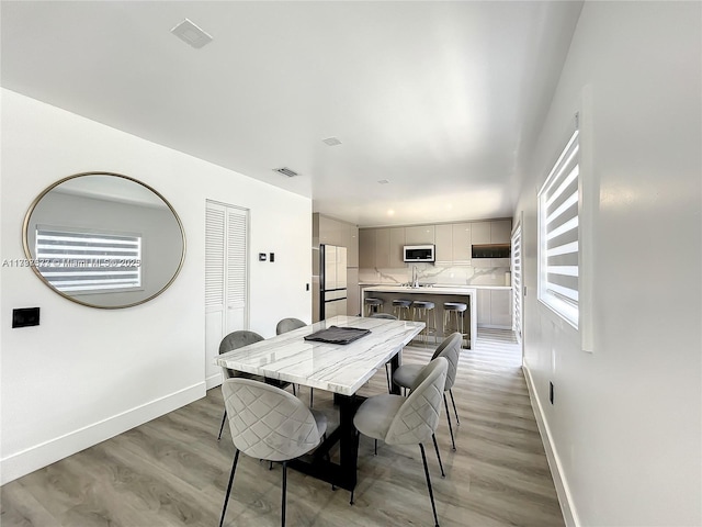 dining room with wood-type flooring