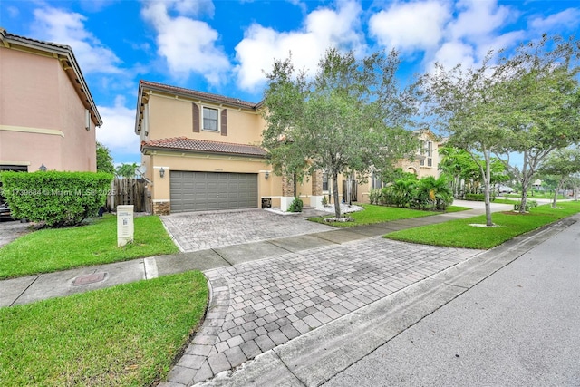 mediterranean / spanish home with a garage and a front lawn