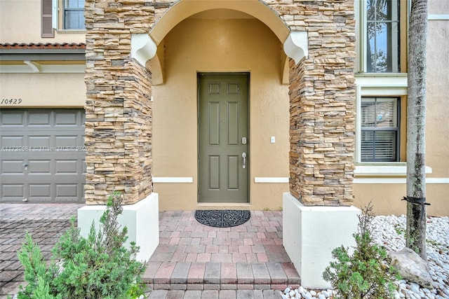 doorway to property with a garage