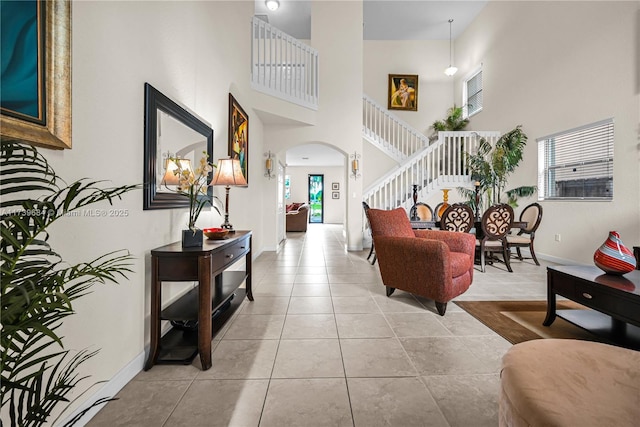 tiled foyer featuring a high ceiling