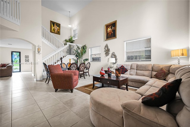 tiled living room with a high ceiling