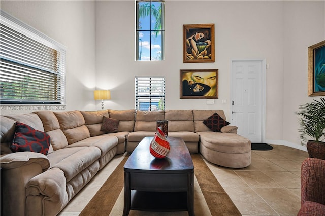 living room featuring tile patterned flooring and a high ceiling