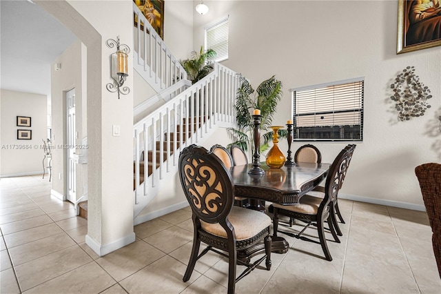 tiled dining room with a high ceiling