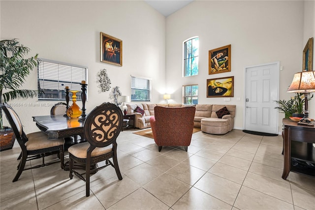 tiled dining space featuring a high ceiling