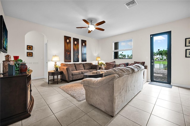 tiled living room featuring ceiling fan