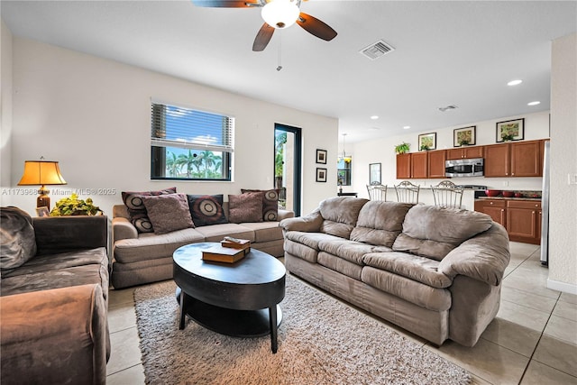 living room with light tile patterned floors and ceiling fan