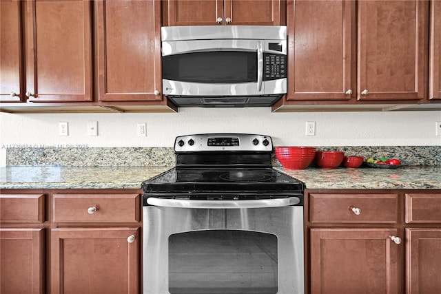 kitchen featuring stainless steel appliances and light stone countertops