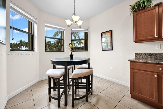 dining room featuring light tile patterned flooring and a chandelier