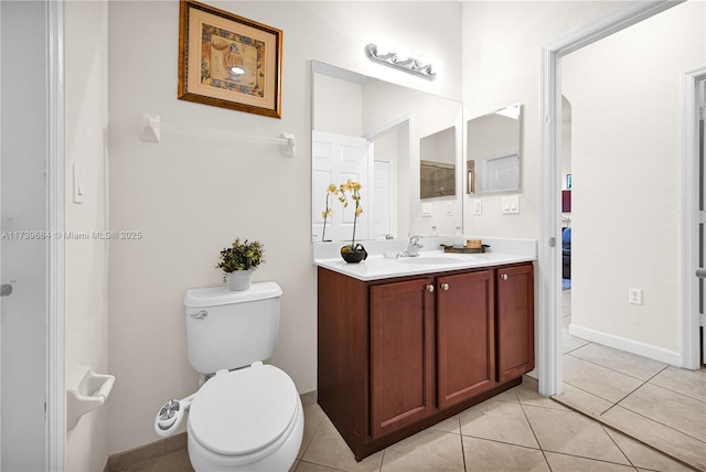 bathroom featuring vanity, tile patterned floors, and toilet