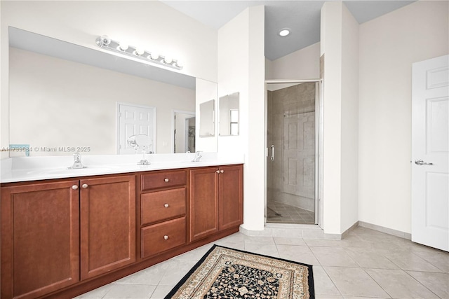 bathroom featuring walk in shower, tile patterned floors, and vanity