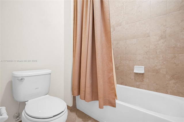 bathroom featuring tile patterned floors, toilet, and shower / bath combo with shower curtain