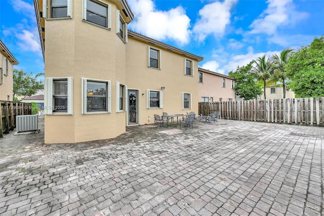 rear view of house with cooling unit and a patio area