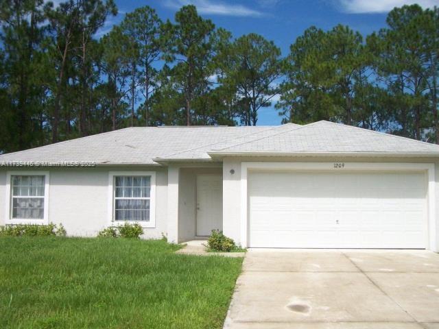 ranch-style house with a garage and a front lawn