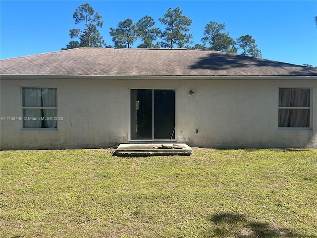 rear view of house with a yard