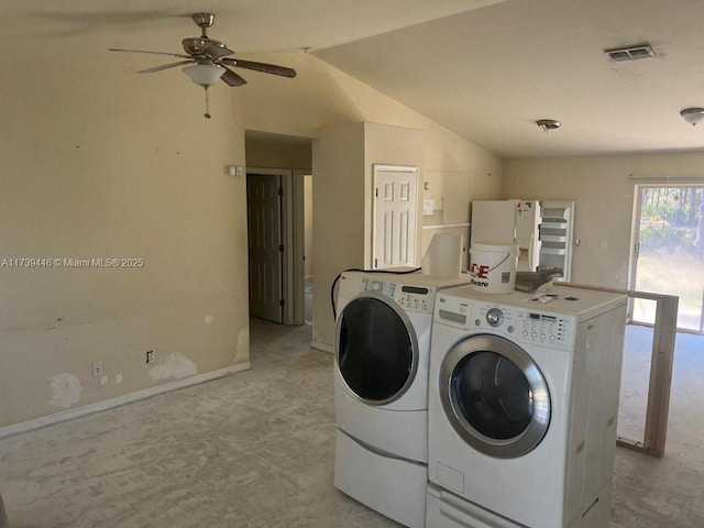 laundry area featuring washer and dryer, light colored carpet, and ceiling fan