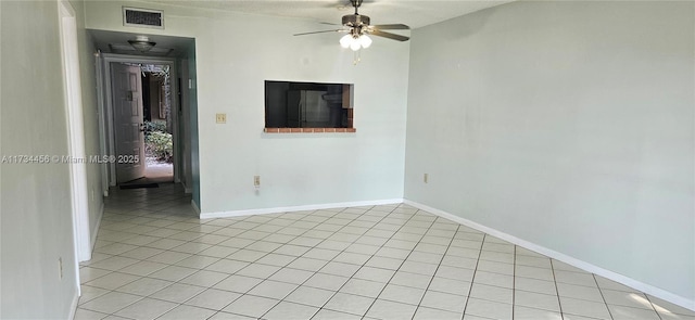 empty room with ceiling fan and light tile patterned floors