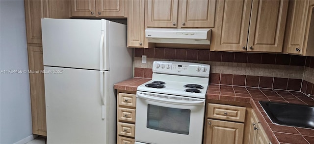 kitchen featuring sink, white appliances, tile counters, and backsplash