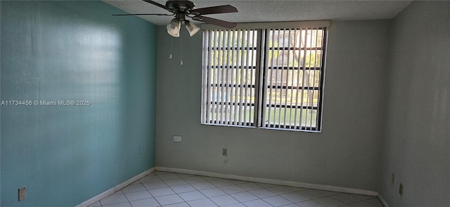 tiled empty room featuring ceiling fan and a textured ceiling