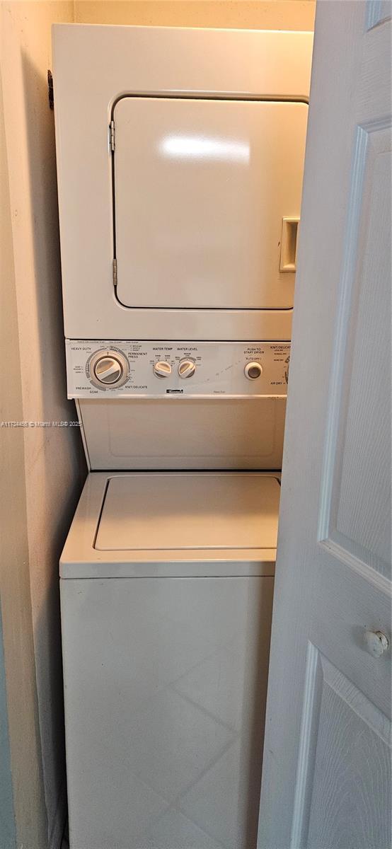 laundry room featuring stacked washer and clothes dryer