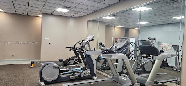 gym with a paneled ceiling