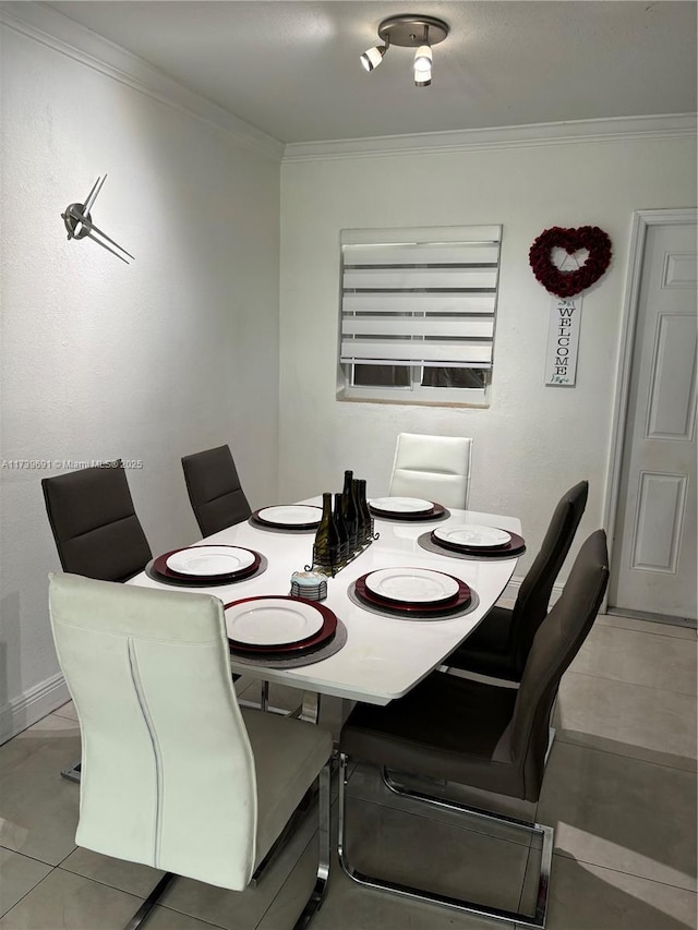 tiled dining area featuring crown molding