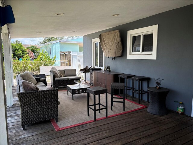 wooden terrace featuring outdoor lounge area