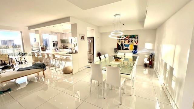 dining room featuring plenty of natural light and light tile patterned floors