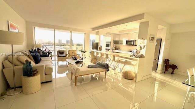living room featuring light tile patterned floors and baseboards