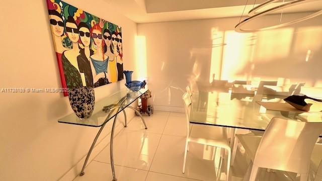 hallway with tile patterned flooring and baseboards