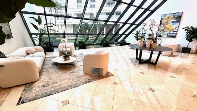 19707 Turnberry Way Unit 10L, Aventura, FL 33180 - living area featuring tile patterned floors, expansive windows, and a high ceiling