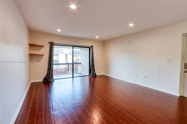 unfurnished room with dark hardwood / wood-style floors