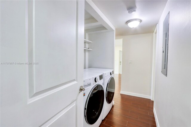 laundry area with dark wood-type flooring and washer and clothes dryer