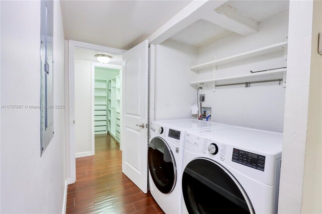 washroom with dark hardwood / wood-style flooring and washer and dryer