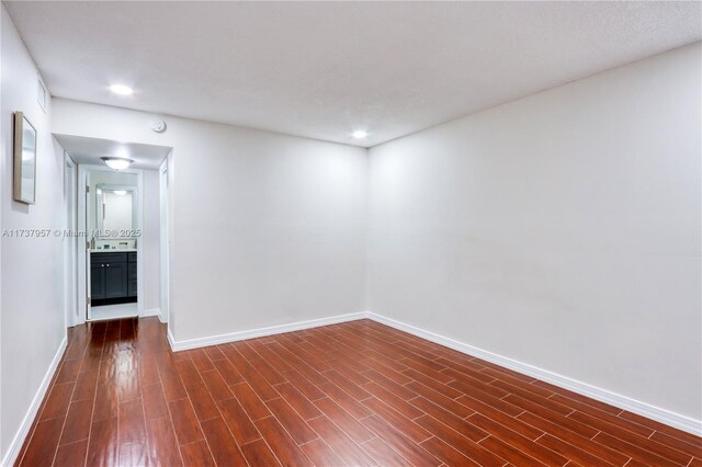 spare room with dark hardwood / wood-style flooring