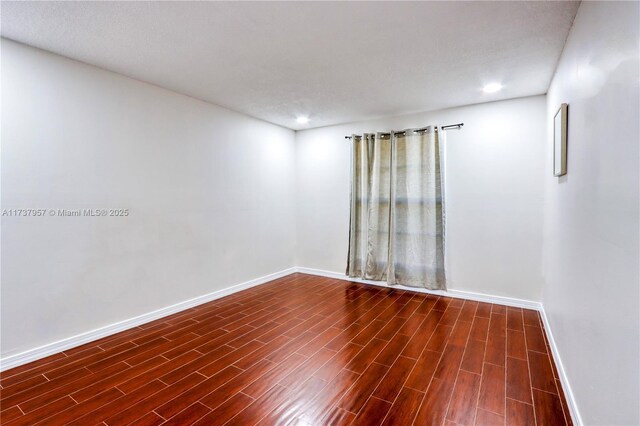 unfurnished room with dark hardwood / wood-style floors