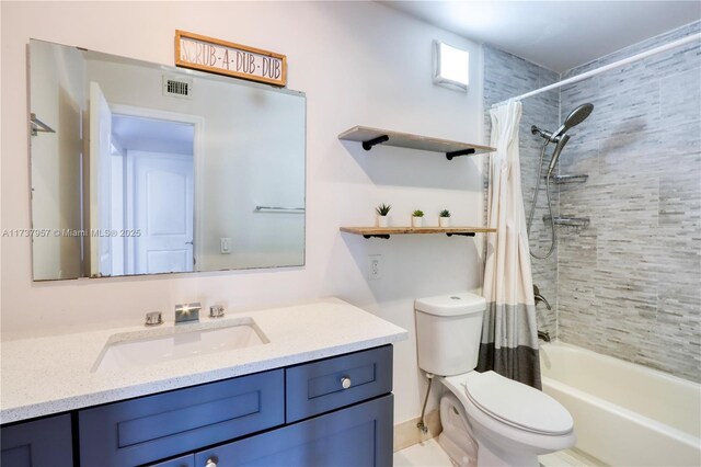 full bathroom with shower / tub combo with curtain, vanity, and toilet