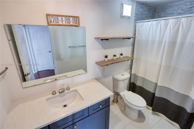 bathroom featuring walk in shower, tile patterned floors, vanity, and toilet