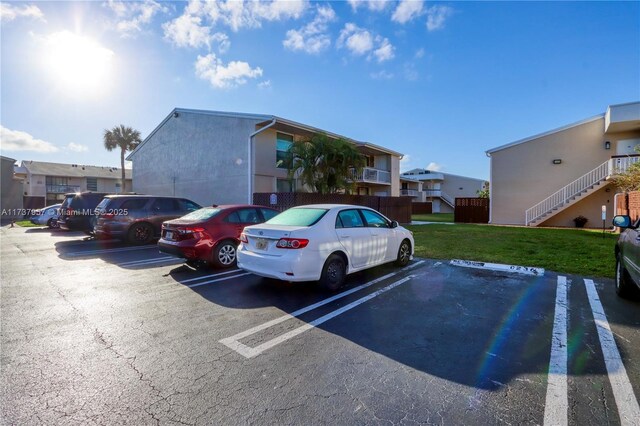 view of parking / parking lot featuring a yard