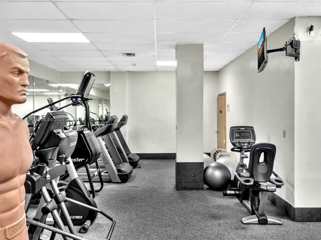 exercise room featuring a paneled ceiling