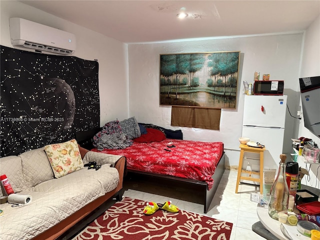 bedroom with a wall mounted air conditioner, light tile patterned floors, and white refrigerator