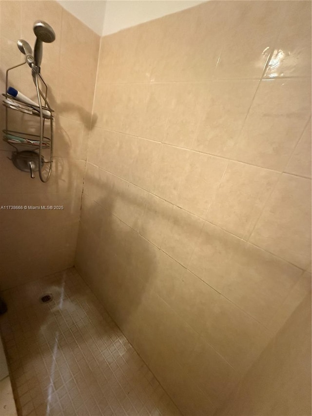 bathroom with a tile shower